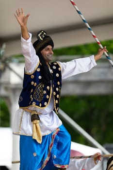 Columbus, Ohio, USA - May 26, 2019: Columbus Asian Festival, Indian men wearing traditional clothing, performing Bhangra traditional dance in the amphitheater at Franklin Park