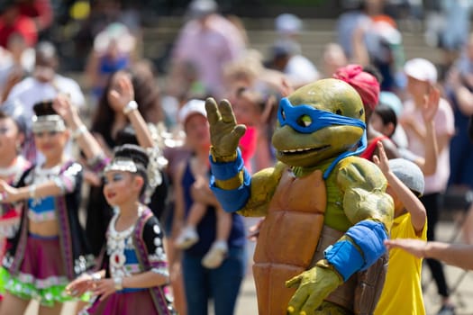 Columbus, Ohio, USA - May 26, 2019: Columbus Asian Festival, members of the spectators wearing traditional clothing, dancing to Bhangra traditional dance in the amphitheater at Franklin Park