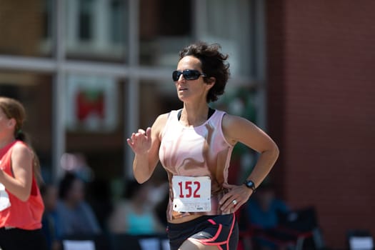 Buckhannon, West Virginia, USA - May 18, 2019: Strawberry Festival, woman runing participating in a race prior to the parade