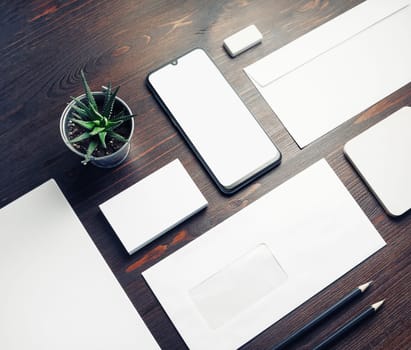 Blank stationery set. Business brand template on wood table background.
