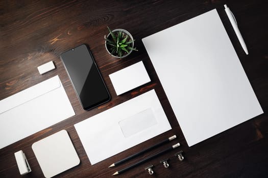 Blank branding identity set on wooden background. Corporate stationery template. For design presentations and portfolios.