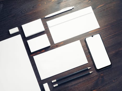 Corporate identity template on wooden background. Photo of blank stationery set. Mockup for design presentations and portfolios.