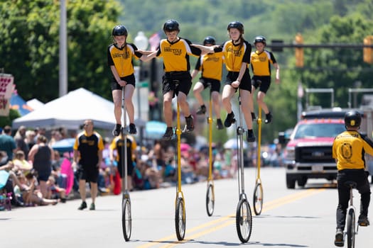 Buckhannon, West Virginia, USA - May 18, 2019: Strawberry Festival, The St. Helen Unicycle Drill Team, riding Unicycles down the street during the parade