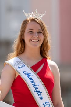 Buckhannon, West Virginia, USA - May 18, 2019: Strawberry Festival, Beauty Contestants, on float, going down Main Street, smiling, waving at spectators, during the parade