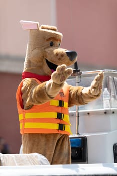 Buckhannon, West Virginia, USA - May 18, 2019: Strawberry Festival, Person dress up as Bobber, promoting water safety, on a boat, going down Main Street