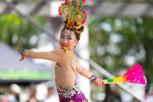 Columbus, Ohio, USA - May 26, 2019: Columbus Asian Festival, Young girls performing Hmong traditional dances, in the amphitheater at Franklin Park