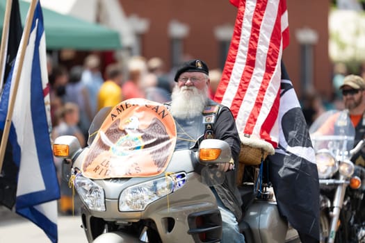 Buckhannon, West Virginia, USA - May 18, 2019: Strawberry Festival, Member of the American Legion Riders on a motorcycle, transporting the American flag during the parade