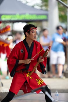Columbus, Ohio, USA - May 26, 2019: Columbus Asian Festival, Members of Takarabune dance group from Japan, wearing traditional clothing performing traditional dances at the Amphitheater in the Franklin Park.
