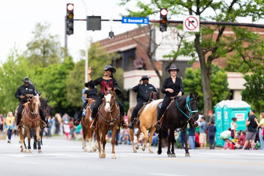 Louisville, Kentucky, USA - May 2, 2019: The Pegasus Parade, Members of the southeastern platinum riderz, riding horses down the street during the parade