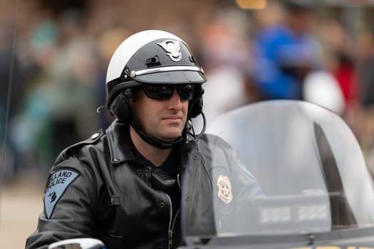 Holland, Michigan, USA - May 11, 2019: Tulip Time Parade, Holland Police Officer riding a motorcycle prior to the parade