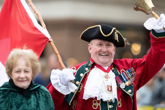 Holland, Michigan, USA - May 11, 2019: Tulip Time Parade, Man and woman wearing traditional dutch clothing going down the street during the parade