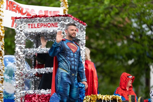 Louisville, Kentucky, USA - May 2, 2019: The Pegasus Parade, People with a float, dress up as superhero chatacters during the parade