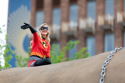 Louisville, Kentucky, USA - May 2, 2019: The Pegasus Parade, Women dress up as superheroes, riding on top of a giant potato during the parade