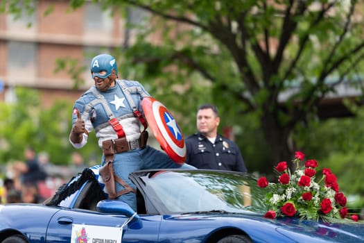 Louisville, Kentucky, USA - May 2, 2019: The Pegasus Parade, man dress up as captain america, riding on a car during the parade