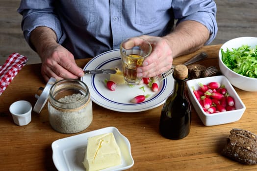 a man eat radishes with butter and salt and drink cider