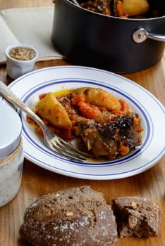 dish with beef carrots and potatoes on table