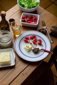 plate with radish and butter on a table