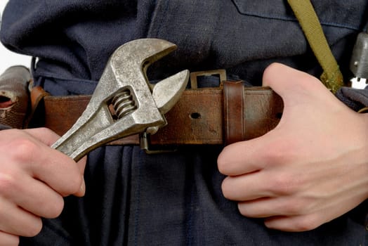 close-up adjustable wrench and hands of mechanic