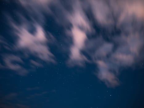 Cloudy sky with moon and stars at night