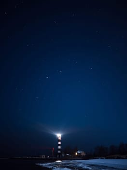 Riga Lighthouse in a starry night with frozen Baltic sea