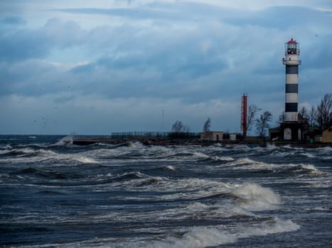 Baltic sea beach with blue cloudy sky and waves