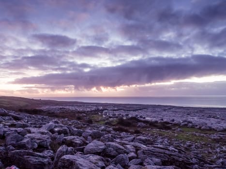 Landscape of sea with dramatic wave and rock in sunset in Ireland