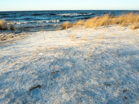 Beautiful view of winter frozen desert dunes on seashore of Baltic sea in Latvia