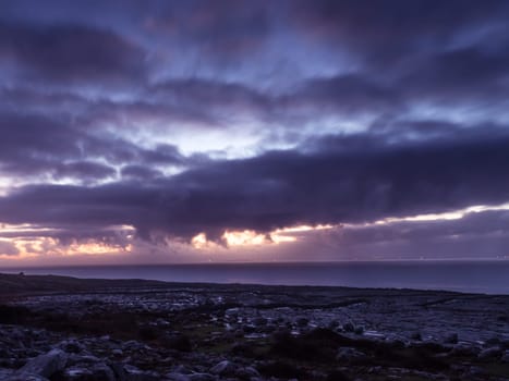 Landscape of sea with dramatic wave and rock in sunset in Ireland