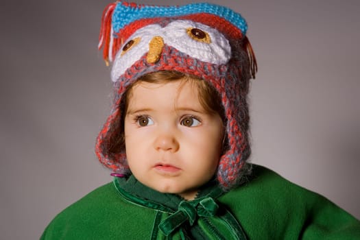 young baby portrait on a grey background