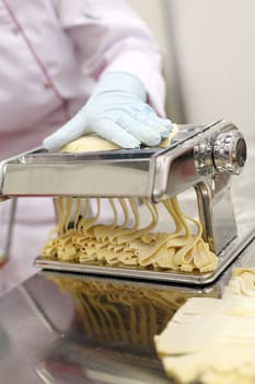A chef is preparing handmade fresh pasta fettuccine and ravioli