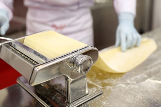 A chef is preparing handmade fresh pasta fettuccine and ravioli