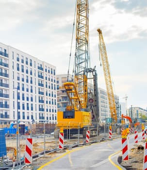 Excavator, cranes and construction equipment at construction site in downtown of Frankfurt , Germany