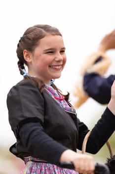Holland, Michigan, USA - May 11, 2019: Tulip Time Parade, Young woman dress up as Dorothy from the Wizard of Oz, Smiling and waving at people during the parade