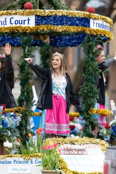 Holland, Michigan, USA - May 11, 2019: Tulip Time Parade, The Bravarian Princess and Court, riding on a float, smiling and waving at spectators