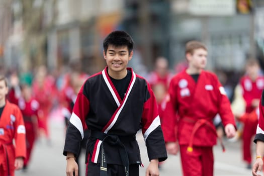 Holland, Michigan, USA - May 11, 2019: Tulip Time Parade, Display by school of martial arts on the street during the parade