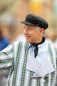 Holland, Michigan, USA - May 11, 2019: Tulip Time Parade, Man wearing traditional dutch clothing, smiling waving at people, going down the road during the parade