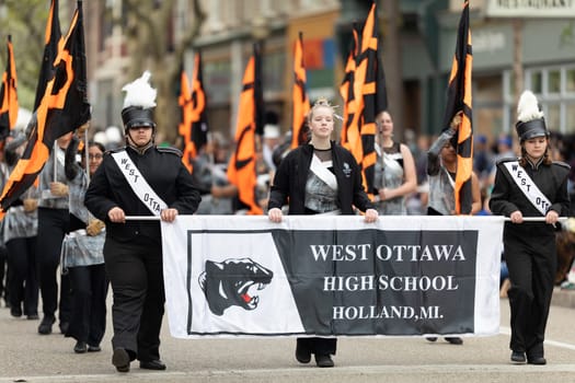 Holland, Michigan, USA - May 11, 2019: Tulip Time Parade, Members of the West Ottawa High School marching band, performing during the parade