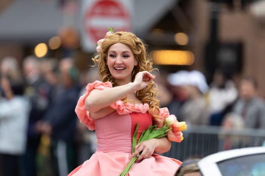 Holland, Michigan, USA - May 11, 2019: Tulip Time Parade, Woman dress up as Disney Character Aurora during the parade