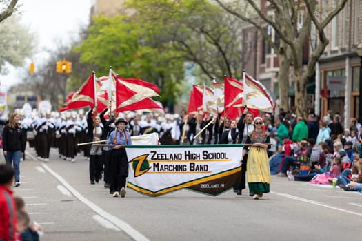 Holland, Michigan, USA - May 11, 2019: Tulip Time Parade, Members of the Zeeland High School Marching Band performing at the parade