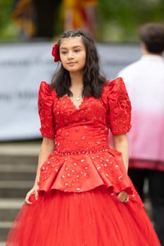 Grand Rapids, Michigan, USA - June 15, 2019: Asian Pacific Festival, Filipino woman displaying a traditional dress during the festival at the Rosa Parks Circle