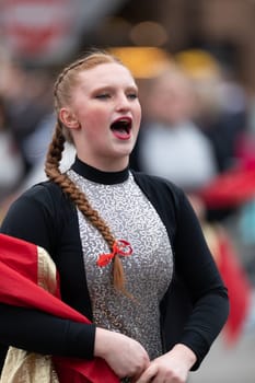 Holland, Michigan, USA - May 11, 2019: Tulip Time Parade, Members of the Zeeland High School Marching Band performing at the parade