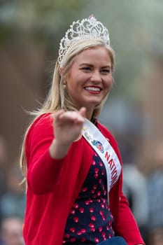 Holland, Michigan, USA - May 11, 2019: Tulip Time Parade, Beauty queens, smiling and waving at the spectators, being transported on the back of a car during the parade