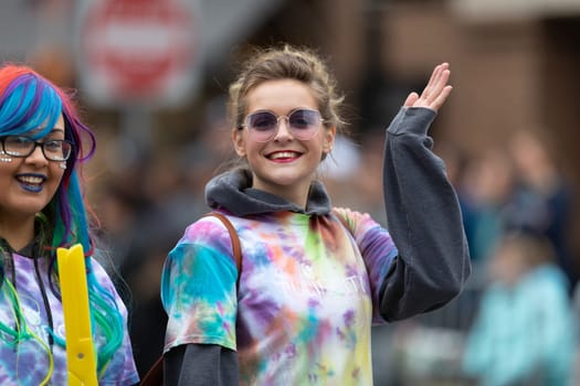 Holland, Michigan, USA - May 11, 2019: Tulip Time Parade, Young women wearing colorful outfits promoting the Tulip Coty Beauty College