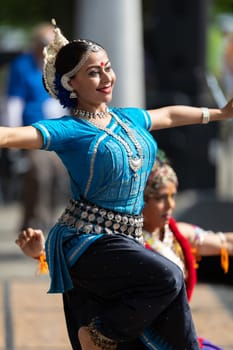 Columbus, Ohio, USA - May 26, 2019: Columbus Asian Festival, Franklin Park, Indian women in traditional clothing, performing traditional Indian dance.