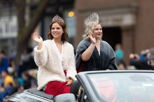 Holland, Michigan, USA - May 11, 2019: Tulip Time Parade, Beauty queens, smiling and waving at the spectators, being transported on the back of a car during the parade