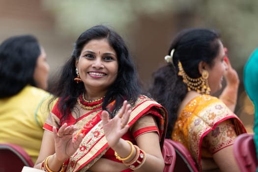Holland, Michigan, USA - May 11, 2019: Tulip Time Parade, Indian woman smiling for the camera, wearing traditional clothing during the parade
