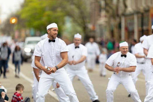 Holland, Michigan, USA - May 11, 2019: Tulip Time Parade, A group of Male Dancers in Uniform, promoting the Hudsonville Ice Cream during the parade