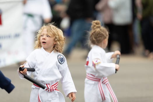 Holland, Michigan, USA - May 11, 2019: Tulip Time Parade, Display by school of martial arts on the street during the parade