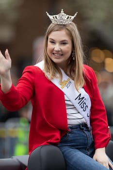 Holland, Michigan, USA - May 11, 2019: Tulip Time Parade, Beauty queens, smiling and waving at the spectators, being transported on the back of a car during the parade
