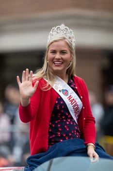 Holland, Michigan, USA - May 11, 2019: Tulip Time Parade, Beauty queens, smiling and waving at the spectators, being transported on the back of a car during the parade